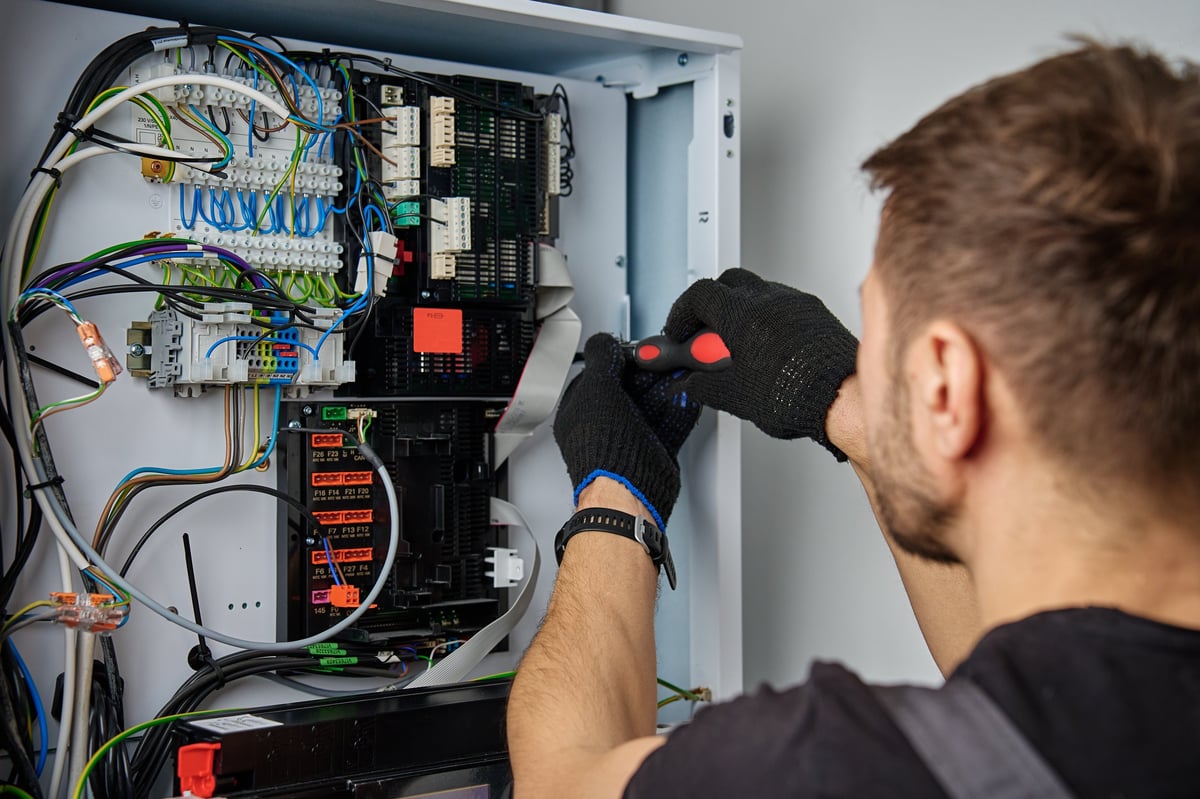 Technician working on furnace control wiring