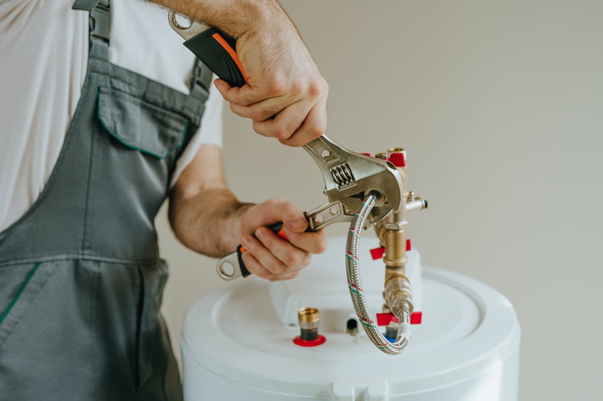 Clark's technician repairing a water heater
